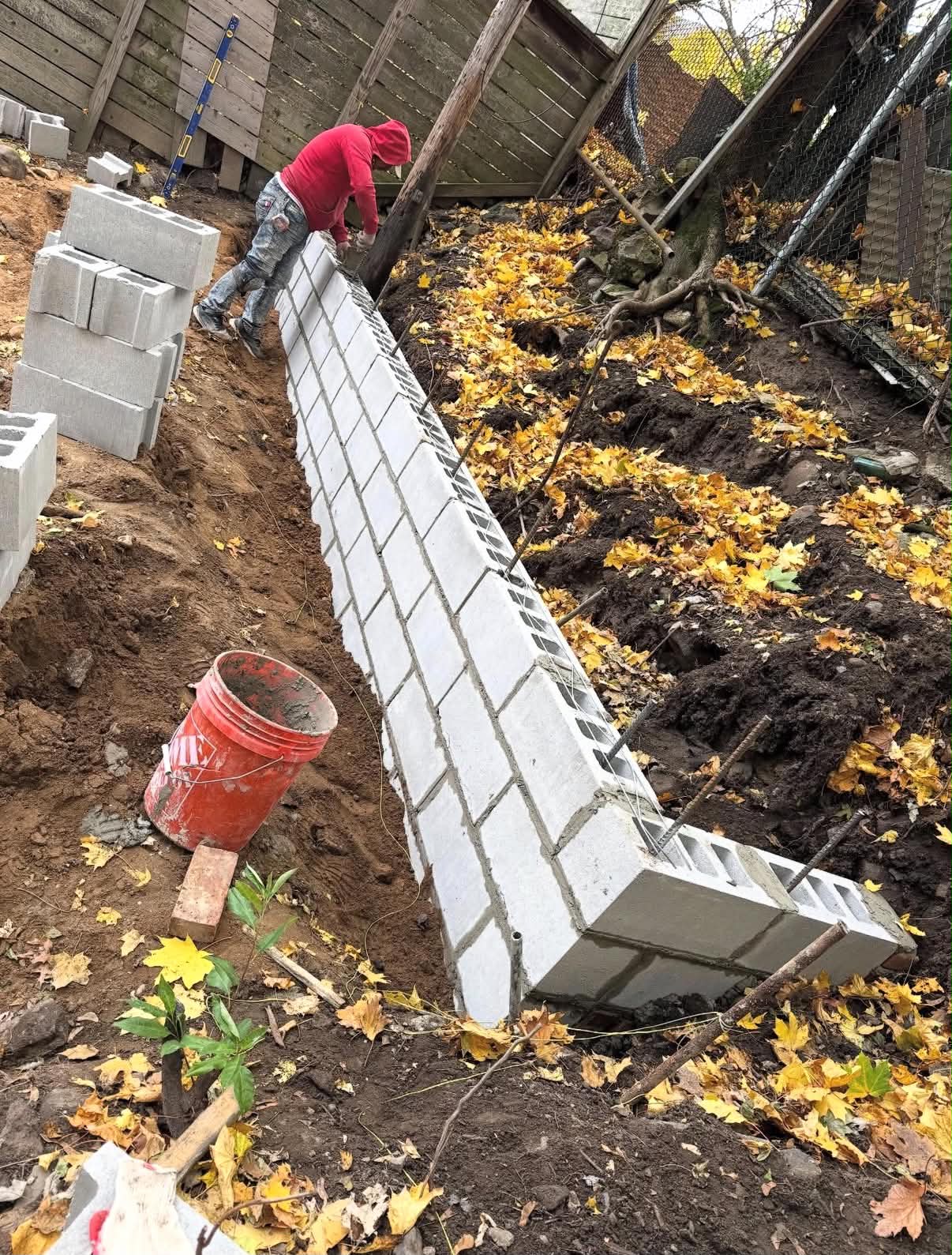 Crew excavating a backyard extension beneath a rear deck